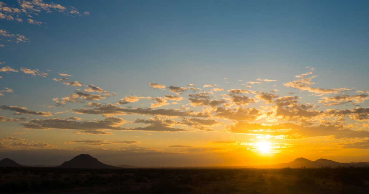 Sun rising over the horizon in the Arizona desert